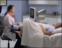 A removable or droppable footboard provides better access and allows the sonographer to avoid shoulder injury by keeping their arm by their side.