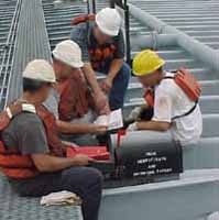 Figure 7: Workers reviewing MSDS information before work begins