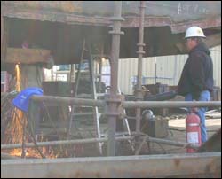 Fire watch observing hot work on a vessel.