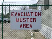 Evacuation Muster Area sign denoting area for workers to gather after evacuating area.