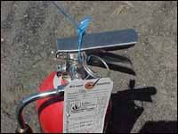 CO2 fire extinguisher with seal and inspection tag.