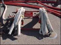 Charged 1-1/2 inch fire hose on main deck of vessel.
