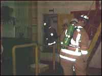 Fireman training in low light conditions in an enclosed space on vessel.