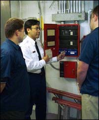 Inspection of fire protection system alarms (shore-based) by fire department personnel.