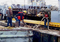 Figure 2: Workers protected with lifejackets (PFDs) while docking and boarding barge
