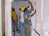 Figure 3: Workers being trained in isolation areas for asbestos removal