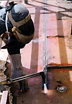 Figure 1: Worker cutting weather deck with torch