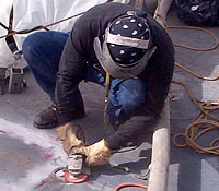 Figure 20: Worker grinding with leather gloves