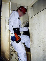 Figure 4: Marine Chemist entering dark space with portable light.