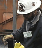 Photo courtesy of OSHA.  Physical inspection precedes job hazard analysis.