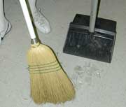 Use a broom and dustpan to clean up broken glass