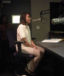 Isabel DeOliveira in a radio broadcasting room