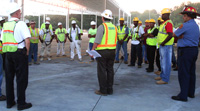 Construction workers in Decatur, Ga., talk about the dangers of heat illness during OSHA's co-sponsored Georgia safety 'stand-down' Aug. 3.