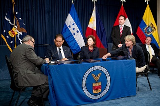 Signing ceremony on Migrant Worker program partnerships, June 11, 2012.  Seated from left: OSHA Assistant Secretary David Michaels,  Ambassador Jorge Ram&oacute;n Hern&aacute;ndez Alcerro of the Government of Honduras, Secretary of Labor Hilda L. Solis and Libby Hendricks of DOL&rsquo;s Wage and Hour Division.