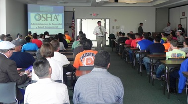 Bill Donovan addressing group of workers.