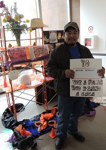 Worker Arturo Soriano holds a sign that reads 