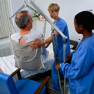 Photograph of healthcare workers assisting a patient | OSHA