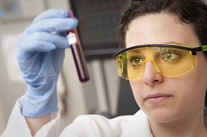 Photo of worker testing a blood sample