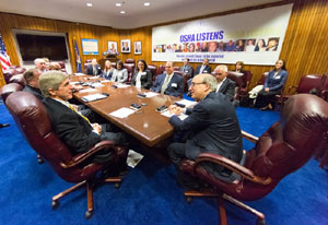 then-Assistant Secretary Dr. David Michaels (Right) chats with Rob DeLucia, vice president and assistant general counsel of Airlines for America, and other members of the Airline Ground Safety Panel before renewing their alliance April 8.