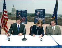 (left to right) OSHA's then-Assistant Secretary John Henshaw, and APA's Executive Director, Julie Heckman sign the Alliance as APA President Michael Collar looks on.