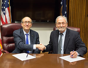 then-Assistant Secretary Dr. David Michaels, USDOL-OSHA, with J.D. Lormand, Executive Director, APCA, at the alliance renewal signing ceremony on October 15, 2015.