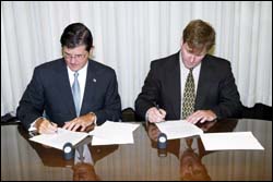 (L to R) OSHA's then-Assistant Secretary John Henshaw and ASHI's Vice Chair, Board of Directors, Tim Eiman sign national Alliance on August 10, 2004.