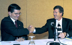 OSHA's then-Assistant Secretary, John Henshaw and John Mayo, Dean, McDonough School of Business shake hands after signing a national Alliance on April 10, 2003.