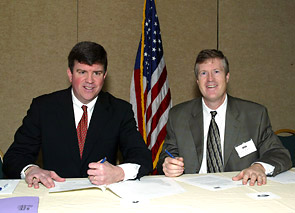(Seated L-R) OSHA's then-Acting Assistant Secretary, Jonathan L. Snare and John W. Mayo, PhD, Executive Director, Center for Business and Public Policy sign national Alliance agreement January 13, 2006.