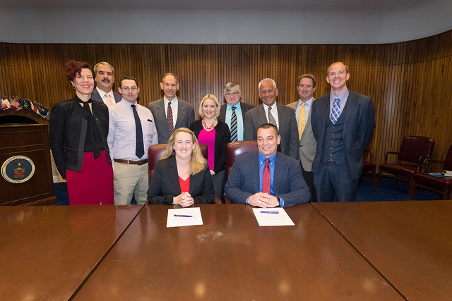 Deputy Assistant Secretary Loren Sweatt, USDOL-OSHA and William "Butch" Chapman, President IWCA (seated, center), with representatives of IWCA and OSHA at the Alliance signing ceremony on February 14, 2018.