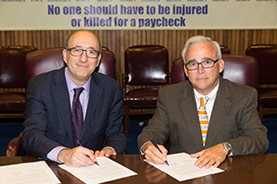 then-Assistant Secretary Dr. David Michaels, USDOL-OSHA and Robert Switzer, Vice President of Operations, Lamar Advertising Company at the alliance renewal ceremony on December 1, 2015.