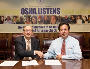 (L to R) then-Assistant Secretary Dr. David Michaels, USDOL-OSHA; and Gus Anibarro, Education Director, LIA sign a national Alliance renewal agreement on December 18, 2014.