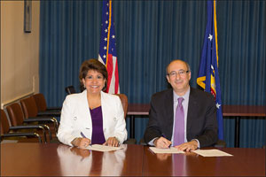 (L to R) Janet Murgu&iacute;a, President and CEO, National Council of La Raza, and then-Assistant Secretary Dr. David Michaels, USDOL-OSHA, sign the OSHA and NCLR Alliance renewal agreement at DOL on September 20, 2013.