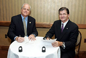 (L to R) NUCA President, William Bowman and OSHA's then-Assistant Secretary, John Henshaw sign national Alliance on December 6, 2004.