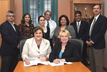 (seated left to right): Gladys Escalona de Mota, Chancellor, University of Puerto Rico R&iacute;o Piedras Campus, and OSHA's Patricia K. Clark, Region 2, Regional Administrator. (standing from left to right): Jorge Ramos, Director-OPASO, Daphne Dom&iacute;nguez, Special Assistant to the Chancellor, Migdalia Ru&iacute;z, DECEP Professor, Carlos Rosado, Director-DECEP, Lymari Orellana, UPR-OSHA Alliance Coordinator, Jos&eacute; A. Carpena, Director, Region II, Puerto Rico Area Office after signing the renewal agreement.
