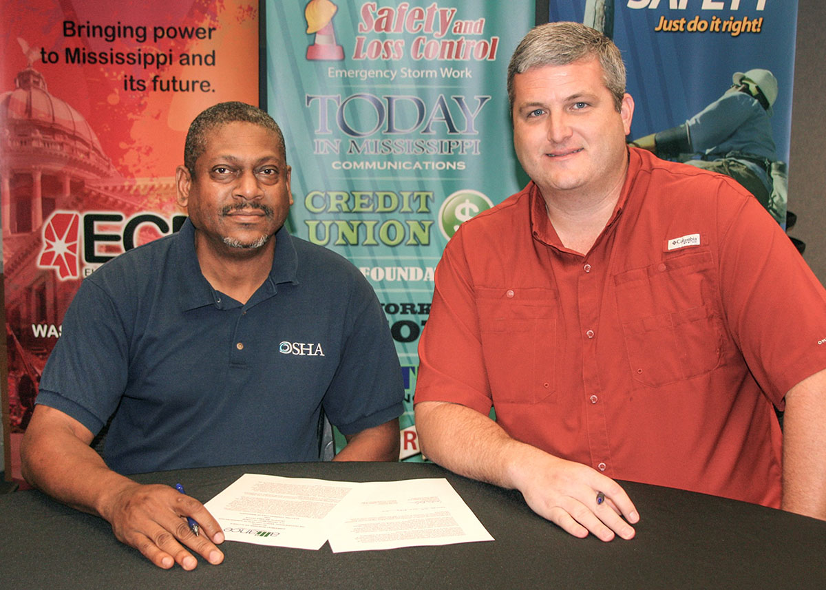 Courtney Bohannon, Area Director, DOL-OSHA- Jackson Area Office, and Gerald Gordon,  Vice President, Safety and Loss Control, ECM, sign the renewal agreement on May 31, 2019.