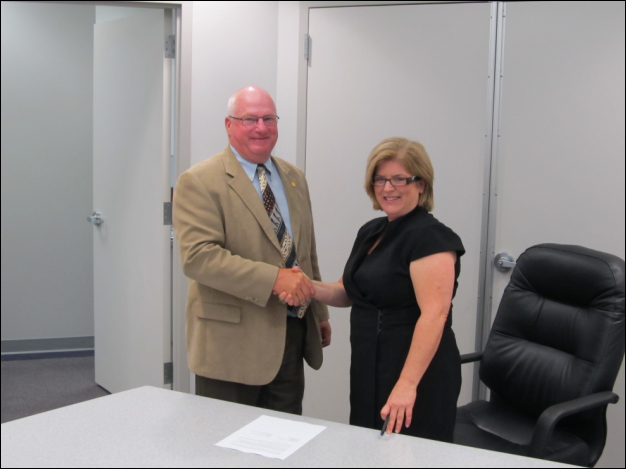 David Wellington, Director, Toledo Electrical Joint Apprenticeship and Training Committee and Kimberly Nelson, OSHA's Region V Toledo, Ohio Office Area Director, after signing the Alliance agreement on August 26, 2011.