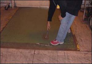 Before - Reaching to the floor to pull a chain that activates the dock leveler