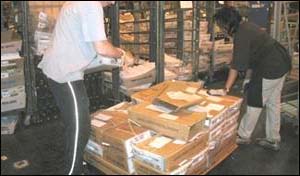 Before - Frequent bending to lift trays of mail from a pallet on the floor
