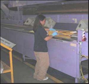 Before - Height of the conveyor results in working above elbow height