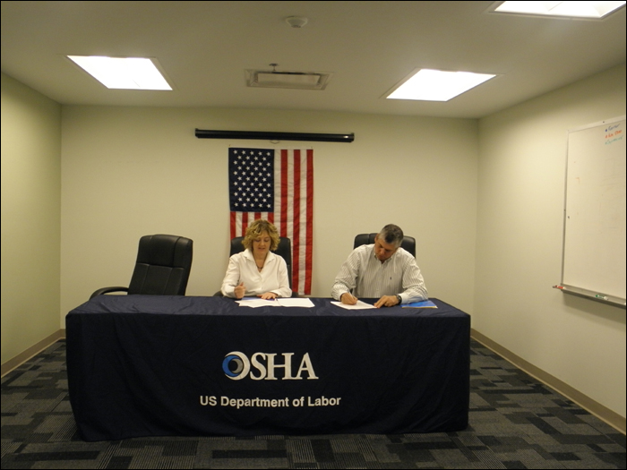 Dorinda Folse, Area Director, Baton Rouge Area Office, US DOL-OSHA and Steve Maslen, Senior Vice President, Clark McCarthy Healthcare Partners, Healthcare Administration, Joint Venture, sign the Partnership agreement on April 1, 2013.