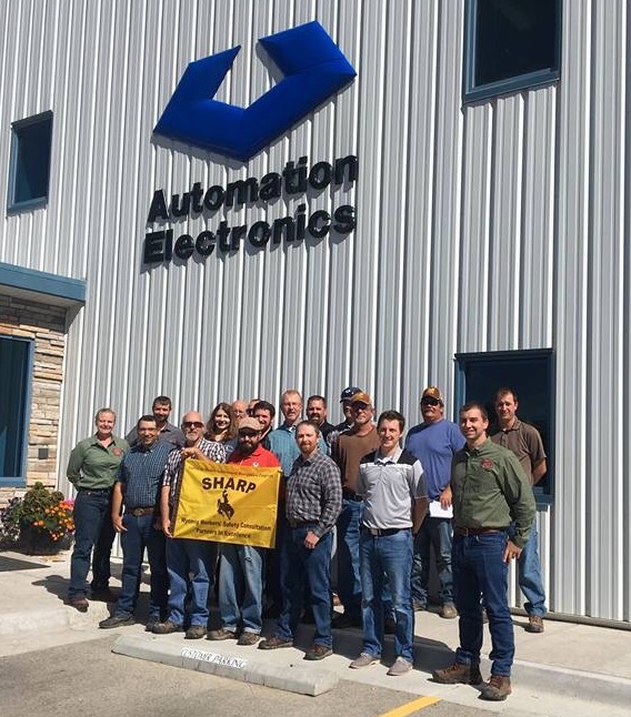 Pictured back row left to right: OSHA Consultation Program Manager; A&E employees -- Brendan Lamb, Mia Kamboris, Tom Hool, Mike Marnell, Justin Gaspar, Bob Dill, Shawn Miller, Ryan Bowar, Ed Brewer, Ryan Ranes, Dane Odde. Front row: Bill Murphy, Brian Morrison, Matt Neuman, Brandon Juday, Hank Tanner and Wyoming OSHA Senior Consultant, Reed Aivazian