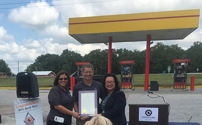 Holding Missouri Governor Eric R. Greiten's proclamation to Bill's Quick Mart:  From left to right:  Linda Collins – Vice President; Bill Spurlock – Owner; and Anna Hui – Director, Missouri Department of Labor