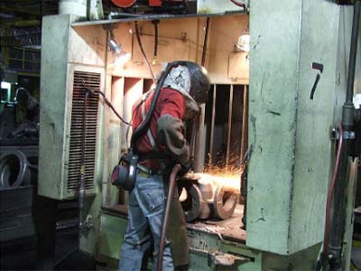 Figure 6. Production module of grinding booth during grinding of a casting. For problems with accessibility in using figures and illustrations, please contact the Directorate of Cooperative and State Programs at (202) 693-2200.