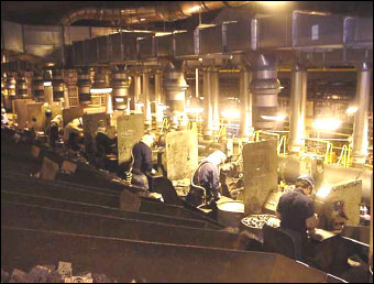 Figure 3. Snag grinding stations with ventilated hoods and overhead "spot" ventilation drops.