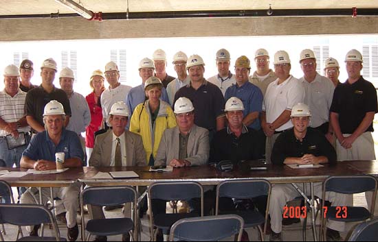 Representatives of AMEC, the construction trades, and OSHA at the Partnership's July 23, 2003 meeting. Front Row (left to right): Gary DiPaolo, Vice President Safety and Heath, AMEC; Gary Anderson, Area Director OSHA Calumet City; Kathy O'Connell, Assistant Area Director, OSHA-Calumet City (standing); Rick Harbour, President Compliance Safety Advocates; Andrew Schaeffer, Territory Safety Manager, AMEC-Central Region; Doug Anderson, Site Safety Manager, Compliance Safety Advocates. Back Row (left to right): Joe Knaff-OSHA, Craig Jorsch-Local 150, Scott Chinn-AFI, Michael Kennedy-AFI, Mona Block-Climatemp, Michael Clifford-Great Lakes Heating & Plumbing, Kevin Johnson-AMEC, Jim Lindquist-AFI, Steve Becker-Gibson Electric, Tom Barilich-AIG, Joe Charczencko-Zurich, Pete Portikis-MTH Industries, Tim Janis-Zurich, Tom Kavicky-UBC, Kenneth Borg-UBC, George Barton-CSA, and Kurt Krueger-CSA)