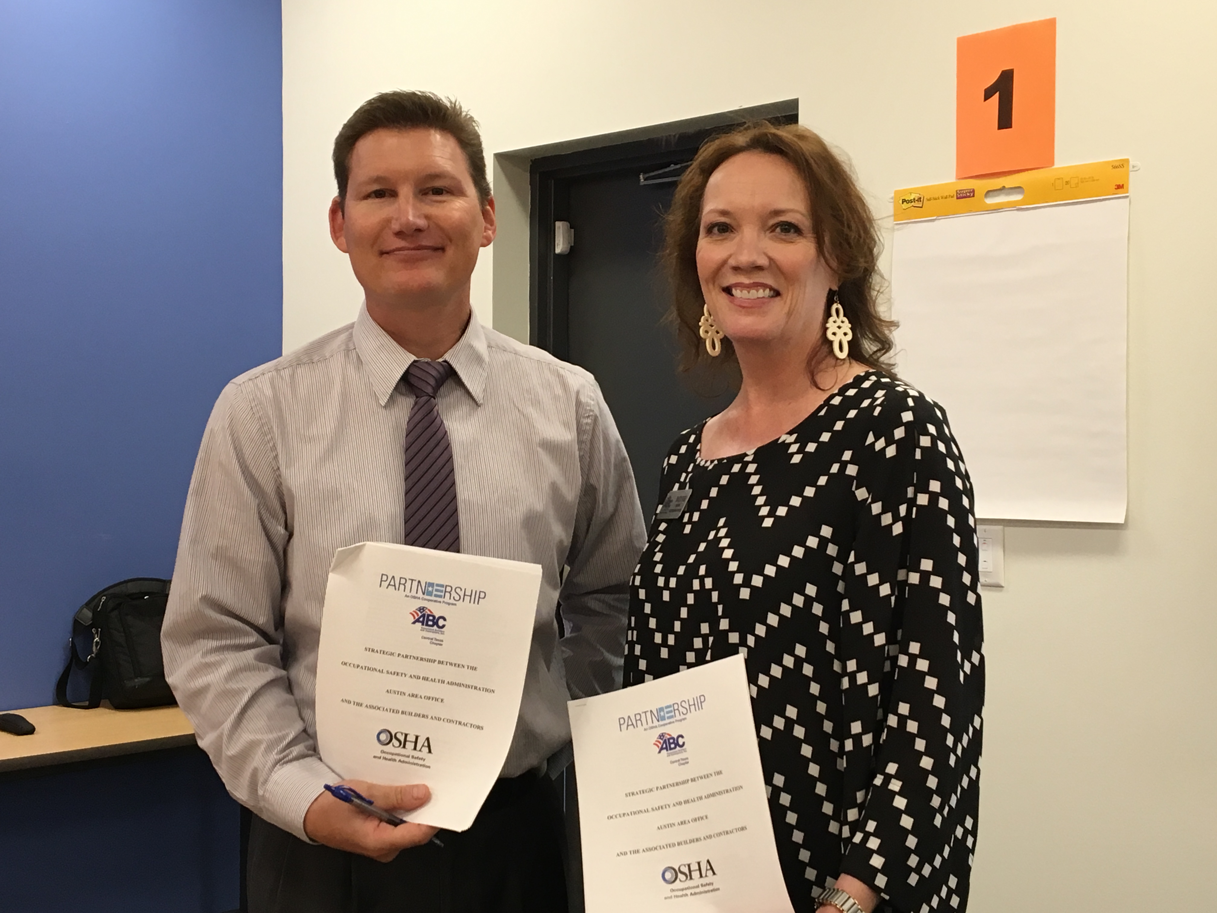 Casey Perkins, OSHA Area Director and Tracy Evers, Executive Director of the Associated Builders and Contractors, Central Texas Chapter renew their OSHA/ABC partnership.