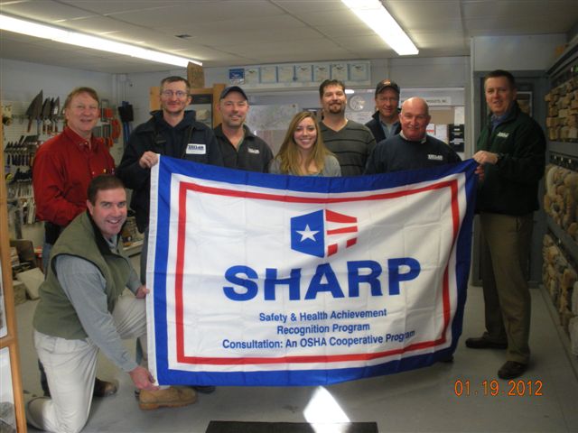 Taylor Concrete Products, Inc., being presented SHARP flag by Mark Silker and Keith Gillette from NYS DOL.