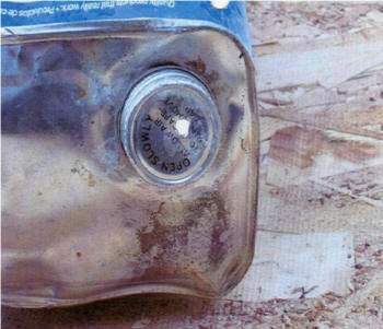 Photo #1: Hole punched into the cap of the can to pour flammable liquid.